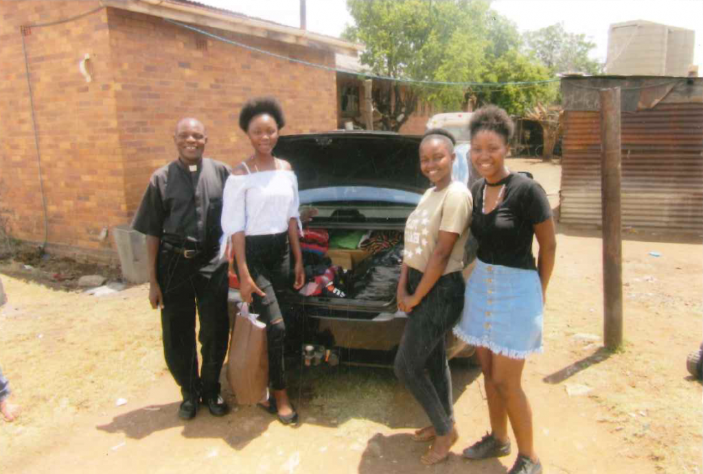 Father Joseph with 3 youths arrived at Dominionville Orphanage with toys and clothing for orphans